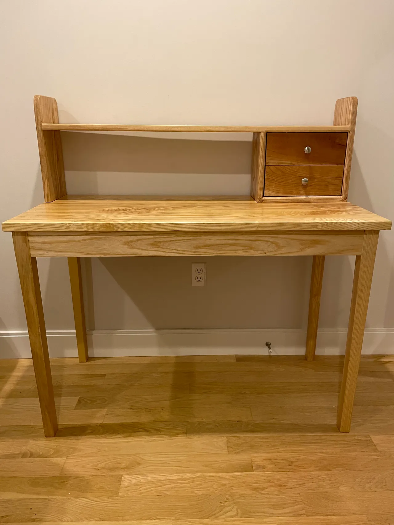 The desk and hutch against a white wall