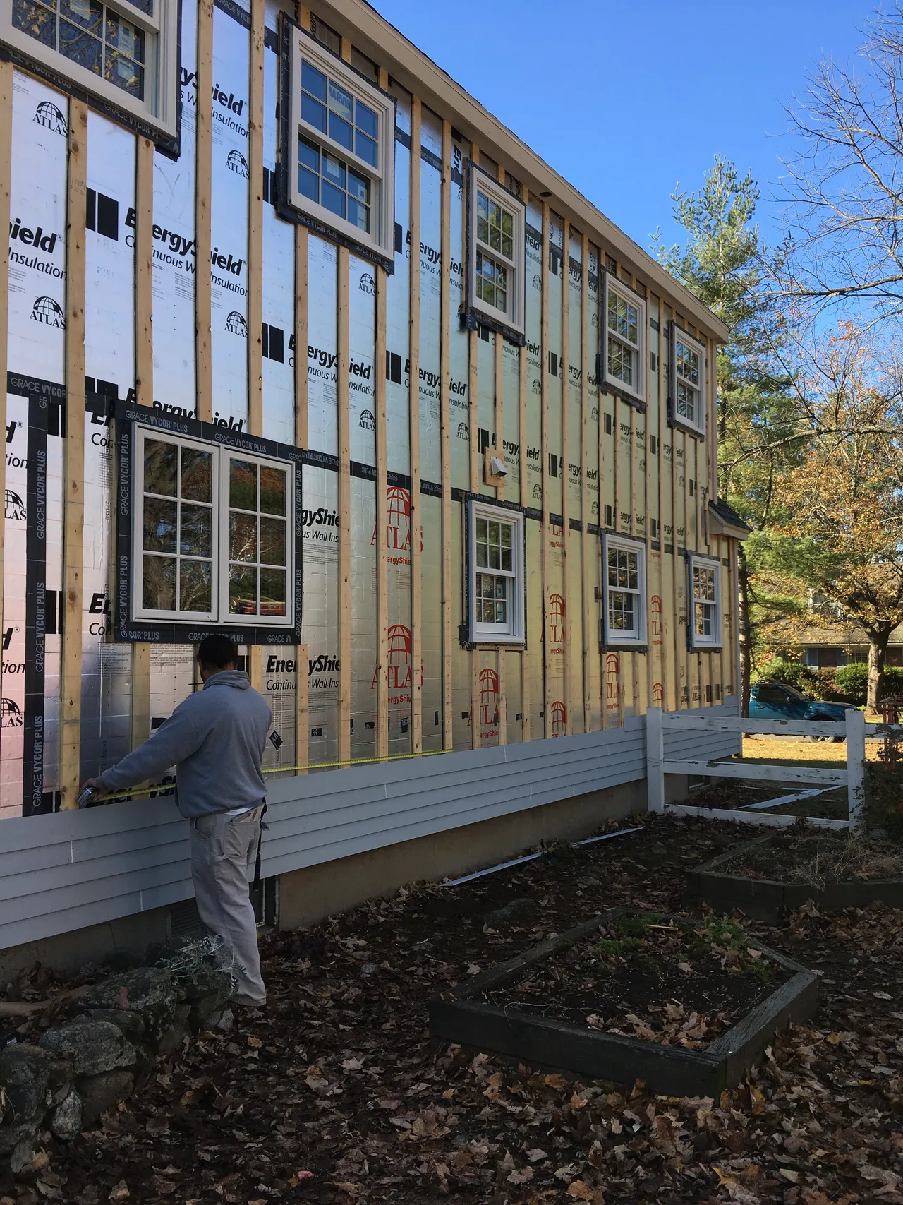 New siding being installed over furring strips