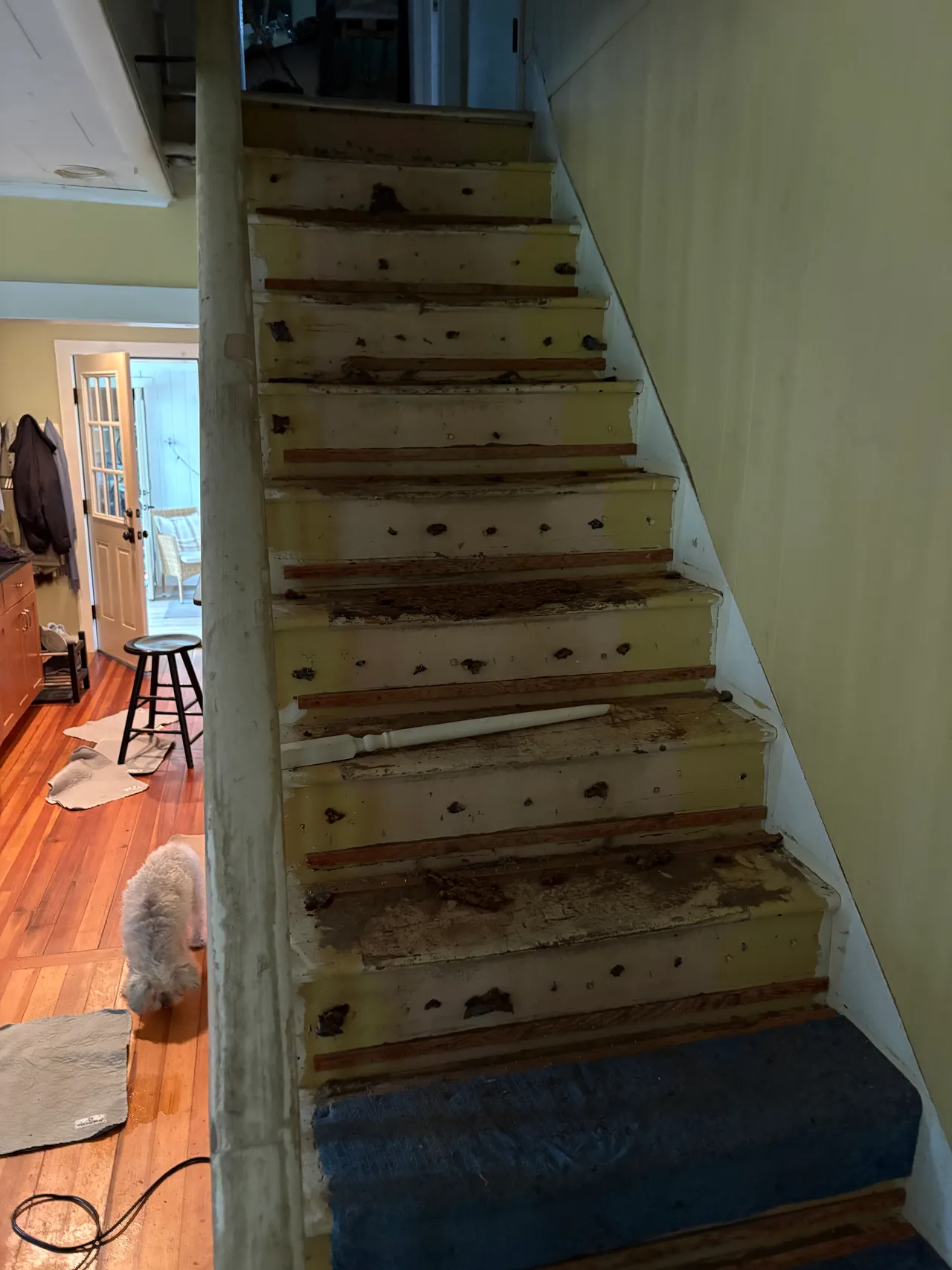 Old staircase with worn treads before the rebuild