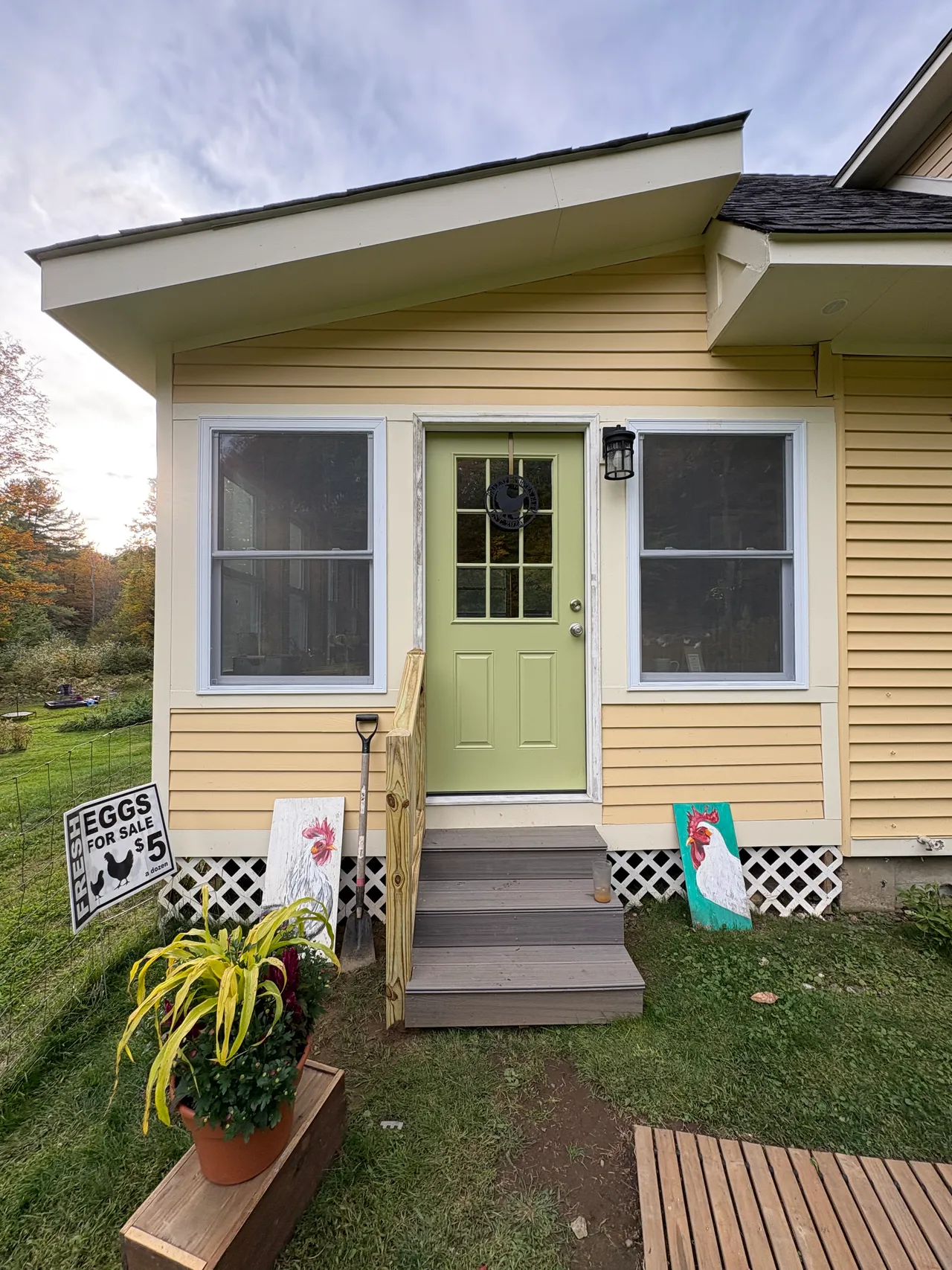 Front of the sunroom with green door and two windows